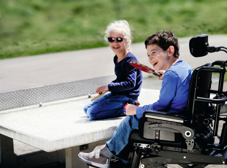 child with disabilities in power chair
